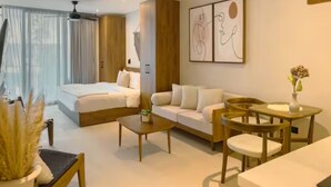 A modern hotel room with a bed, sofa, coffee table, and dining area. - New Studio @ Xibalba | Private Pool + King Bed (Tulum)
