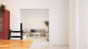 A living room with a wooden dining table, a sofa, and a coffee table. - Family, Sunny safe & cozy choice 1 Km Athens 3 bedrms, 120 sq.m  1300 sq.ft 1st (Kesariani)