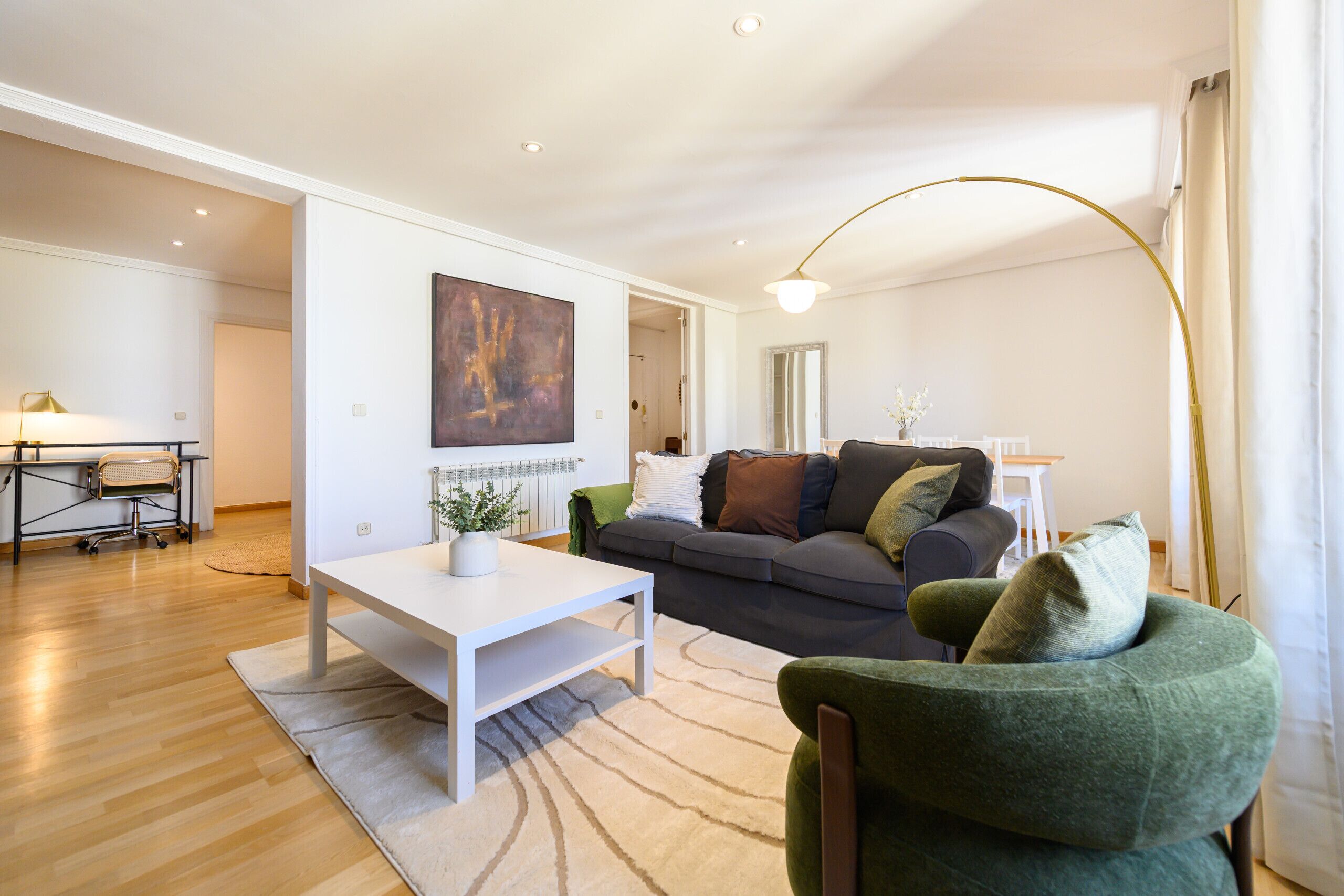 A modern living room with a sofa, a coffee table, and a lamp.