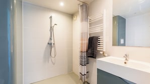 A modern bathroom with a shower, a sink, and a mirror. - 402 - L'Herblinois - Wifi - Proche tram (Saint-Herblain)