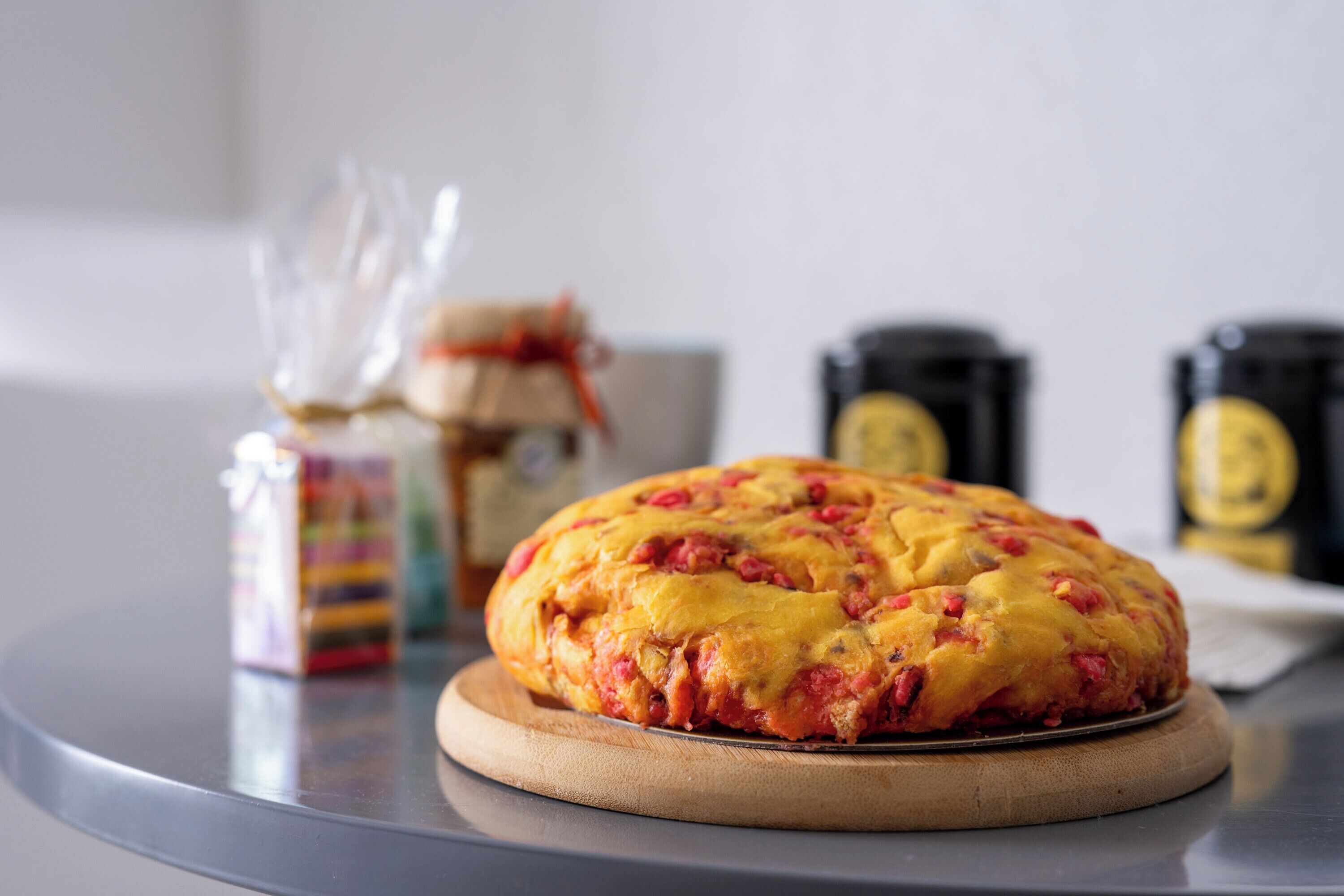 A round, baked dish on a wooden board.