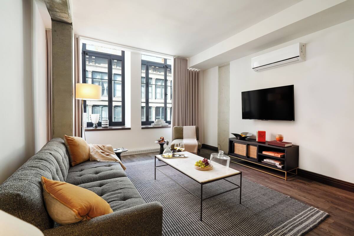 A modern living room with a sofa, coffee table, and TV.