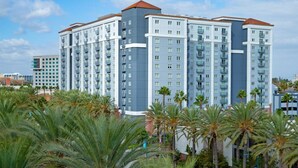 A multi-story hotel with balconies, palm trees, and a clear sky. - Family sized 2 BR, 2 Bath, 6 guest resort condo 5 minutes to Disneyland (Anaheim)