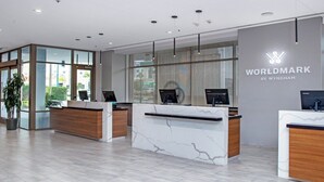 A modern reception desk area with glass partitions, a large window, and a sign reading 'WORLDMARK BY WYNDHAM'. - Family sized 2 BR, 2 Bath, 6 guest resort condo 5 minutes to Disneyland (Anaheim)