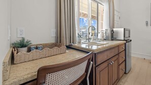 A kitchen with a sink, a coffee maker, a toaster, and a refrigerator. - Bella Notte by the beach Studio 8 (Pleasure Point)