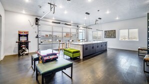 Une cuisine spacieuse dotée d’un grand îlot central, d’un éclairage moderne et offrant une vue sur la ville.