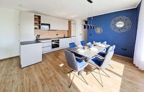 A modern kitchen with white cabinets, a microwave, and a built-in oven. - Luxurious home in Mandre with private swimming pool, can be inside or outside (Mandre)