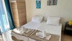 A double bed with two pillows, a bedside table with a lamp, and a wall-mounted air conditioner. - Corfu Frodo Studios, Few Moments From the Beach (Corfu)