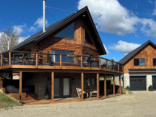 Enjoy an updated classic log cabin with ski slope views from the hot tub.