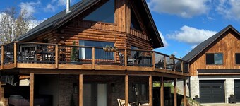 Enjoy an updated classic log cabin with ski slope views from the hot tub.