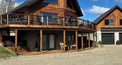 Enjoy an updated classic log cabin with ski slope views from the hot tub.