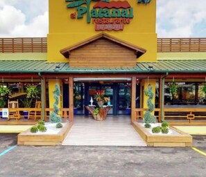 A restaurant named 'El Platanal Restaurante' with a green roof, wooden entrance, and potted plants. - Villa De Gloria - Luxury Stay - Memorable Experiences (Bayamon)