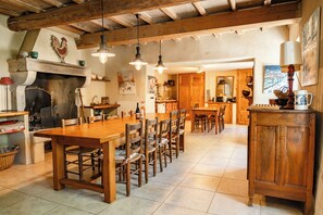 A rustic kitchen with wooden furniture, a fireplace, and hanging lights. - Maison Margerie - Provencal farmhouse with swimming pool and view of Mont Ventoux (Colonzelle)
