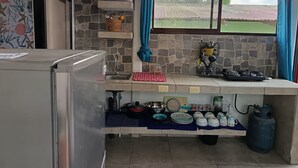 A kitchen with a gas stove, sink, and various kitchen utensils. - Cute studio with AC near Chaman beach Uvita Puntarenas (Uvita)