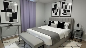 Un dormitorio moderno con cama, banca, mesitas de noche y arte abstracto en la pared.