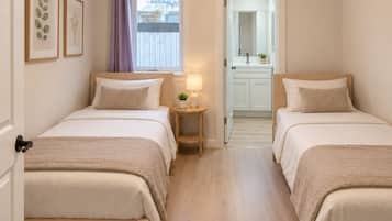 Bedroom 2 features two twin beds and private bathroom.