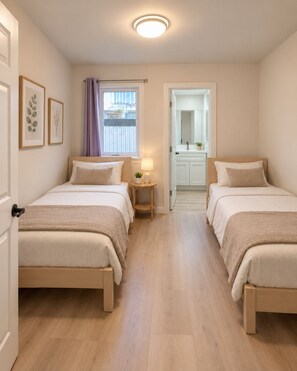 Bedroom 2 features two  twin beds and private bathroom. - Modern 2BR 2BA Apartment Garden-View (San Francisco)