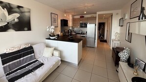 A modern apartment with a living area, kitchenette, and a dining area. - ZEN - Port Ambonne Apartment  PA311 - Luxury - 2 people (AGDE)