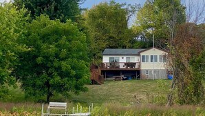 A house with a deck, a dock, and a pond. - Water Front Lake House - Black Lake, NY (Ogdensburg)