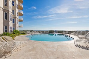 A swimming pool with lounge chairs and a view of the sea. - Oceanfront Penthouse Retreat – 7th Floor at Ocean Place (Fernandina Beach)