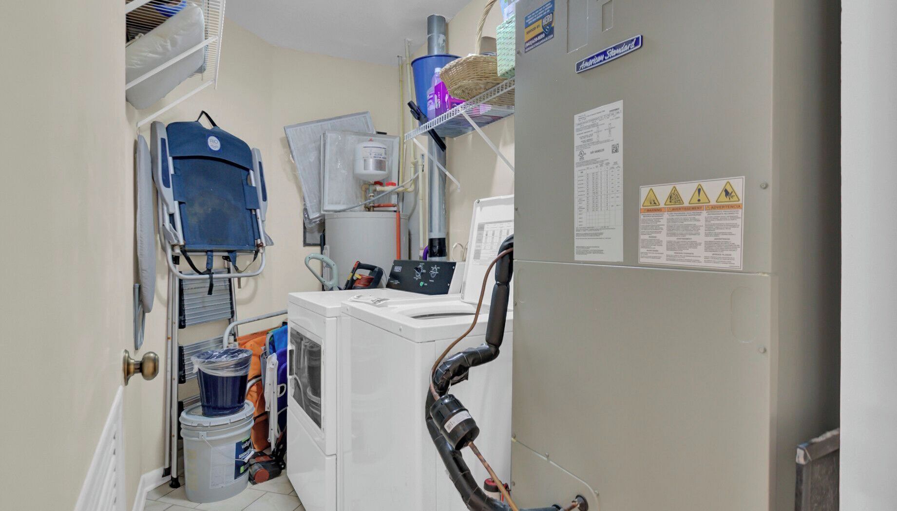 A clinical room with medical equipment, a bed, and a sink.