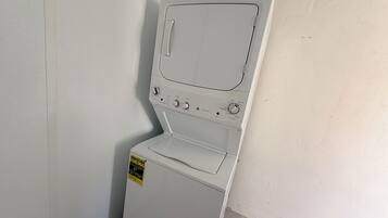 A compact, white front-loading washing machine with a control panel, a front control knob, and a yellow energy efficiency label.