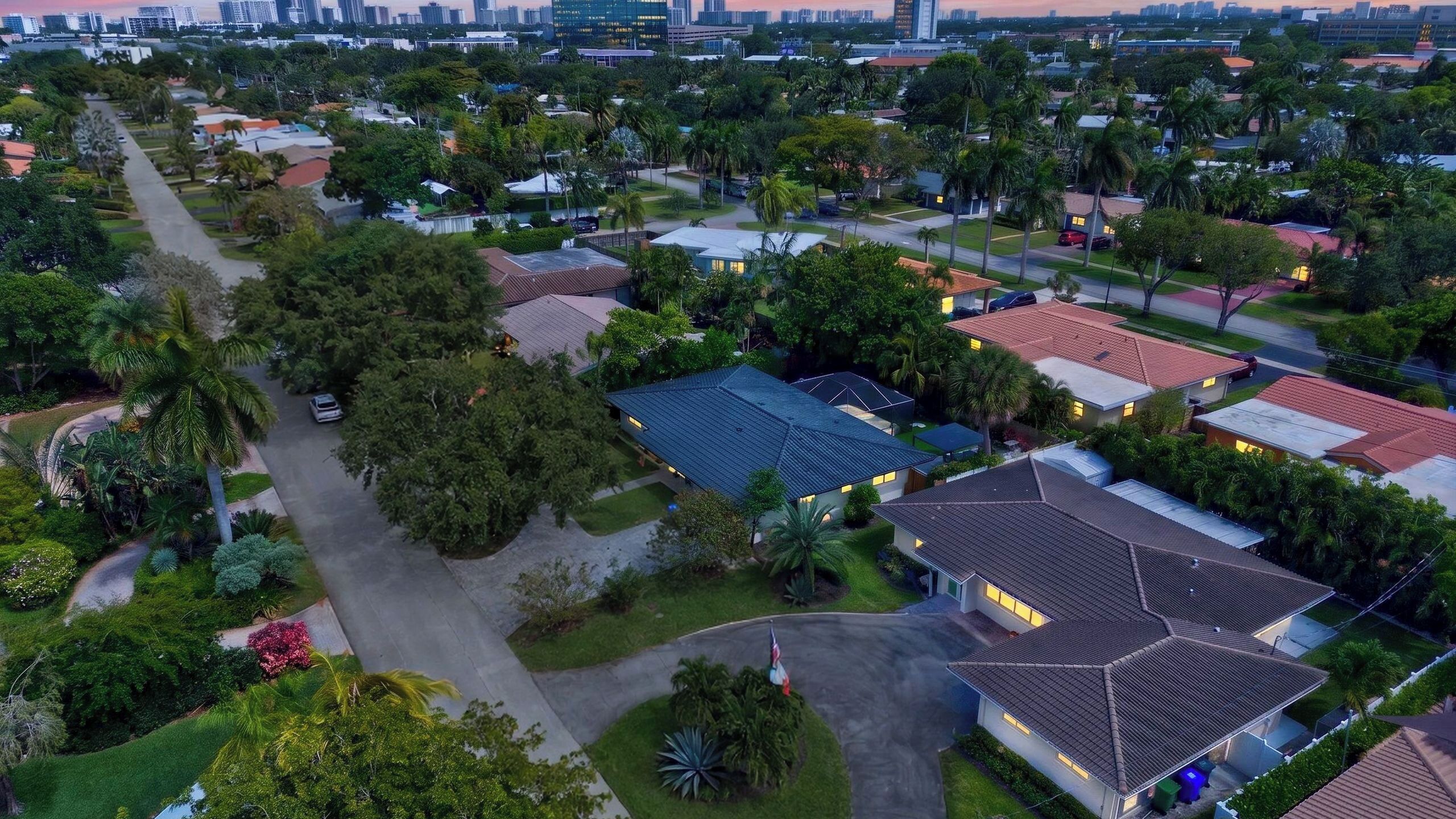 A residential area with houses, roads, and greenery.