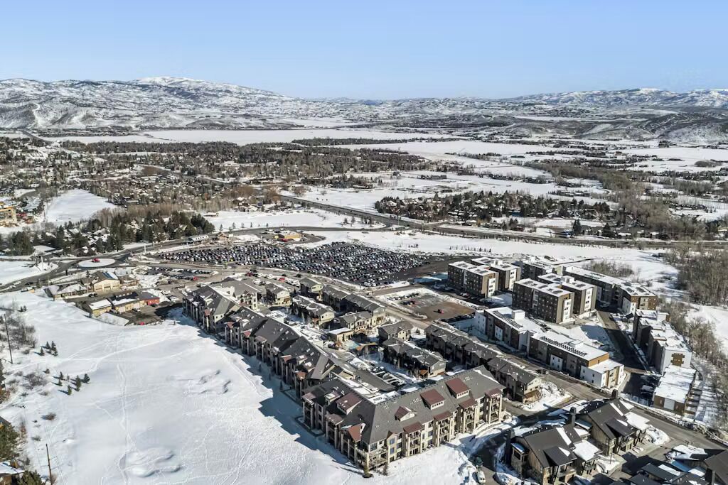 A snow-covered town with a large hotel complex featuring multiple buildings and a central courtyard.