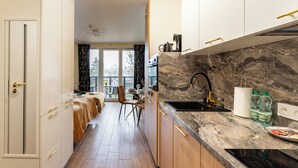 Une cuisine moderne avec un pare-feu en marbre, des armoires en bois et un coin repas offrant une vue agréable.