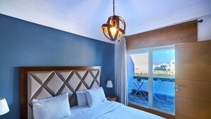 A bedroom with a bed, a nightstand, a lamp, a window with a view, and a door. - Spot Bonheur downtown Wi-Fi Fiber + balcony (Casablanca)