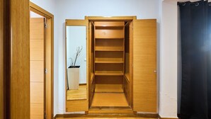 A wooden closet with multiple shelves and a mirror. - Spot Bonheur downtown Wi-Fi Fiber + balcony (Casablanca)