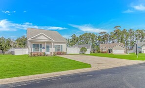 A residential area with single-family homes, a well-maintained lawn, and a clear sky. - 3652 Claypond Village Ln (Myrtle Beach)
