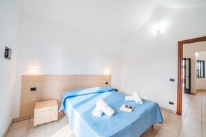A hotel room with a bed, bedside table, and a nightstand. - Beach in 5 min | Pool Access | n.58, Otranto, Italy (Otranto)