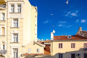 A building with a traditional architectural style, featuring a balcony with ornate railings and a satellite dish on the roof. - Luxury City Apartment Adialuxe S4, Rijeka, Croatia (Rijeka)