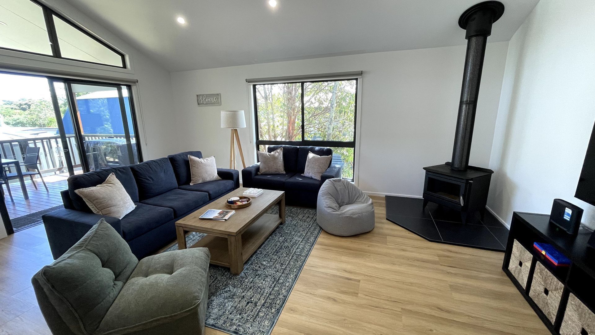 A modern living room with a sofa, coffee table, and a fireplace.