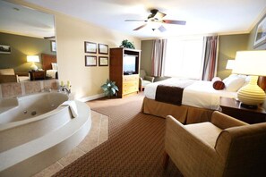A hotel room with a large bathtub, a bed, a television, and a ceiling fan. - Wonderful 2-Bedroom Condo Located at Pollard Brook (Lincoln)