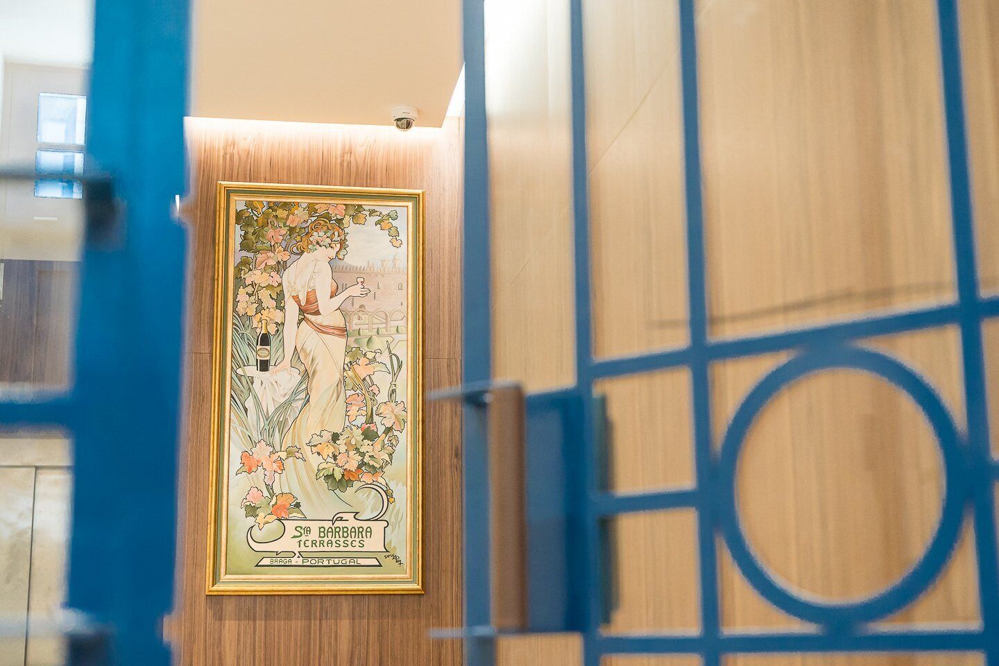 A framed map of Braga, Portugal, with a woman holding a bottle of wine.
