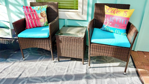 Two wicker chairs with cushions and a glass table on a porch. - Walking distance to the Beach! 2 kitchens! Ground floor access! (Galveston)