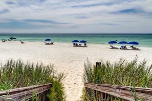 A beach with wooden pathways, beach umbrellas, and lounge chairs. - Gulf Front w/ Amazing Panoramic Gulf Views! Seacrest Beach | Private Beach Access (Seacrest Beach)