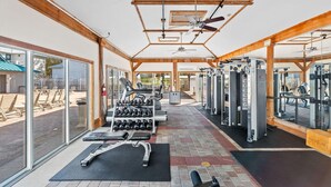 A gym with exercise equipment, large windows, and a ceiling fan. - Awesome 4 Bedroom overlooking Pool / Easy Beach Access (Santa Rosa Beach)