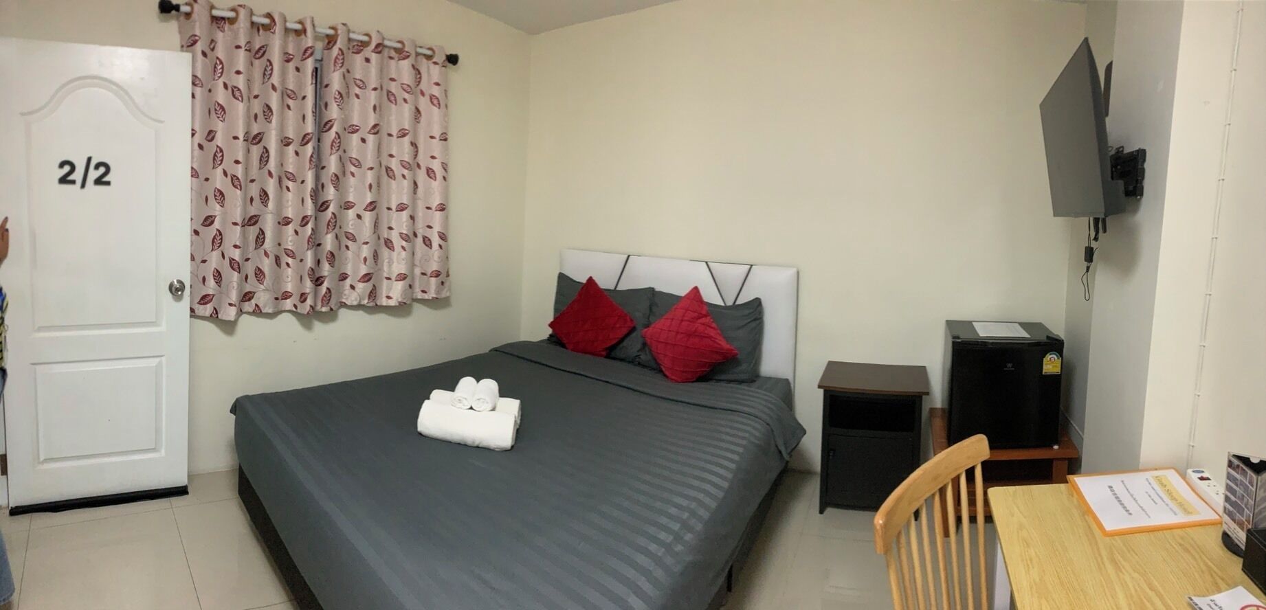 A bedroom with a bed, a desk, a chair, a TV, and a door marked '2/2'.