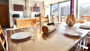 A modern kitchen with a dining area.