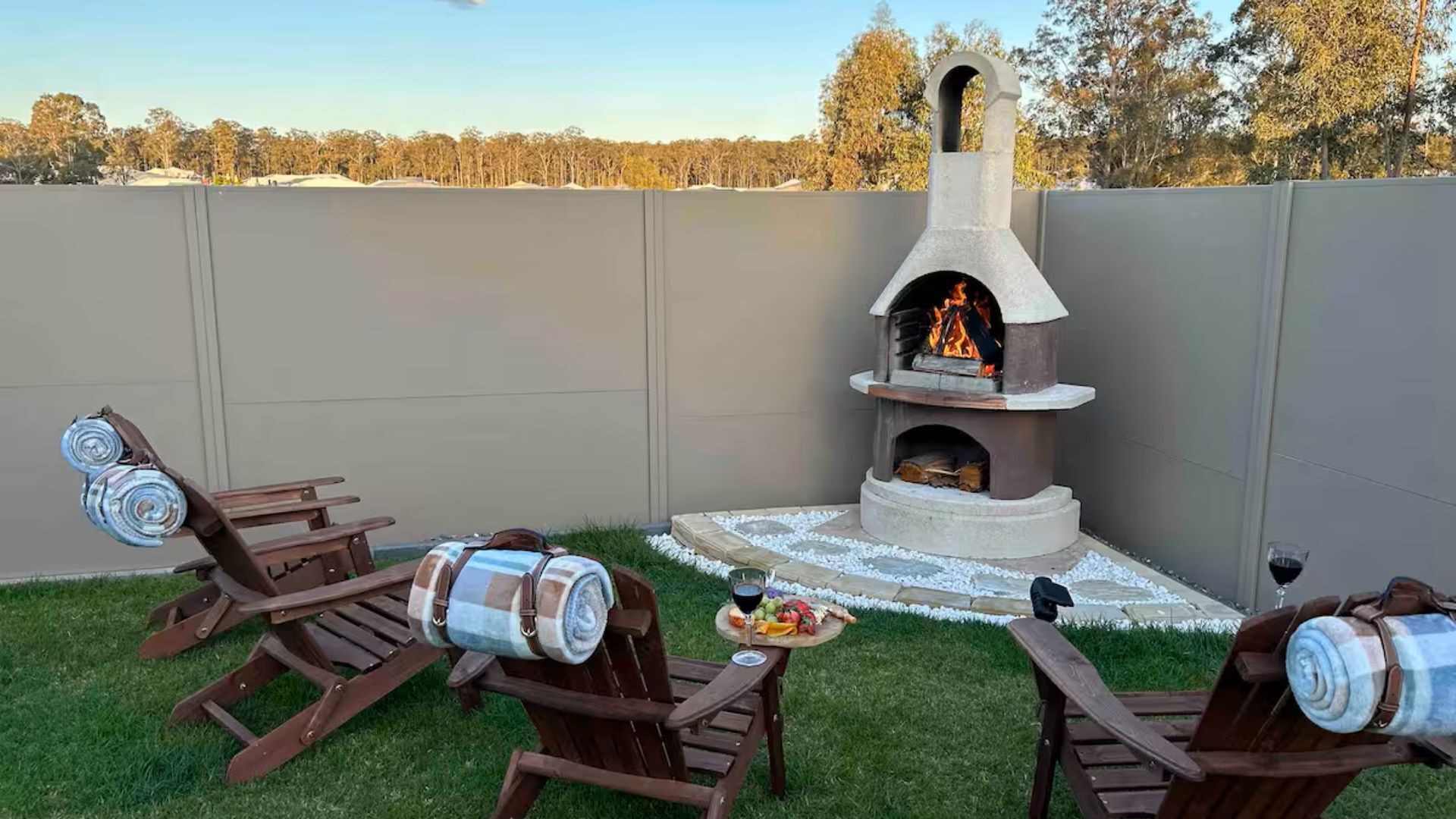 Cozy outdoor fireplace with chairs—perfect for relaxing by the fire.