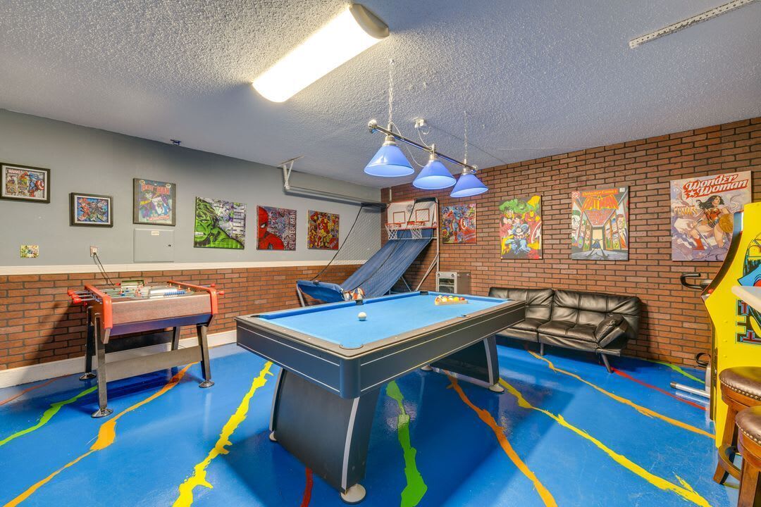 A pool table with a blue felt surface, a slide, and a pool table with a red felt surface.