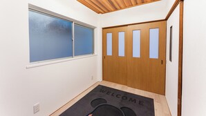 A room with a wooden ceiling, a window with frosted glass, a door with frosted glass panels, and a welcome mat. - Recommended for USJ, Osaka Sight Seeing,Newly Reno! 5min walk to station. 2bed (Osaka)