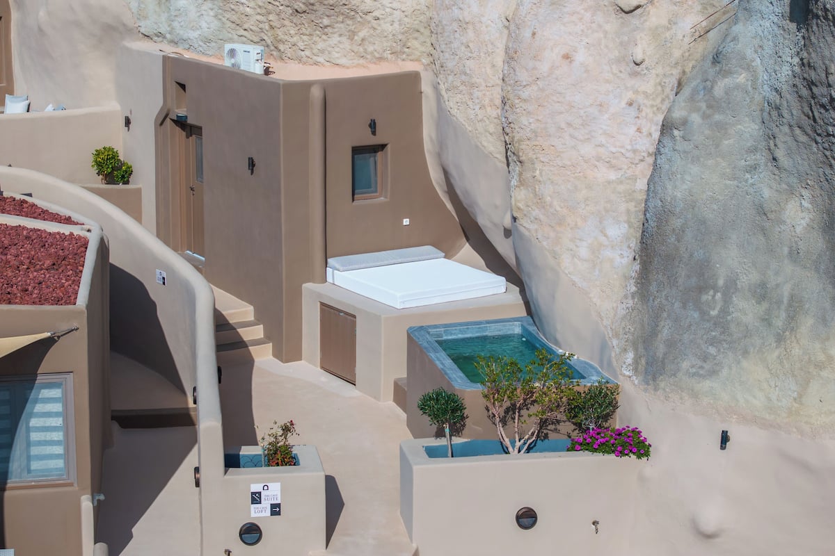 A hotel with a pool, a loft, and a view of the surrounding landscape.