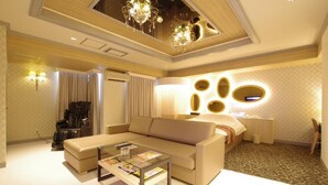 A modern living room with a sofa, coffee table, and a ceiling light fixture.