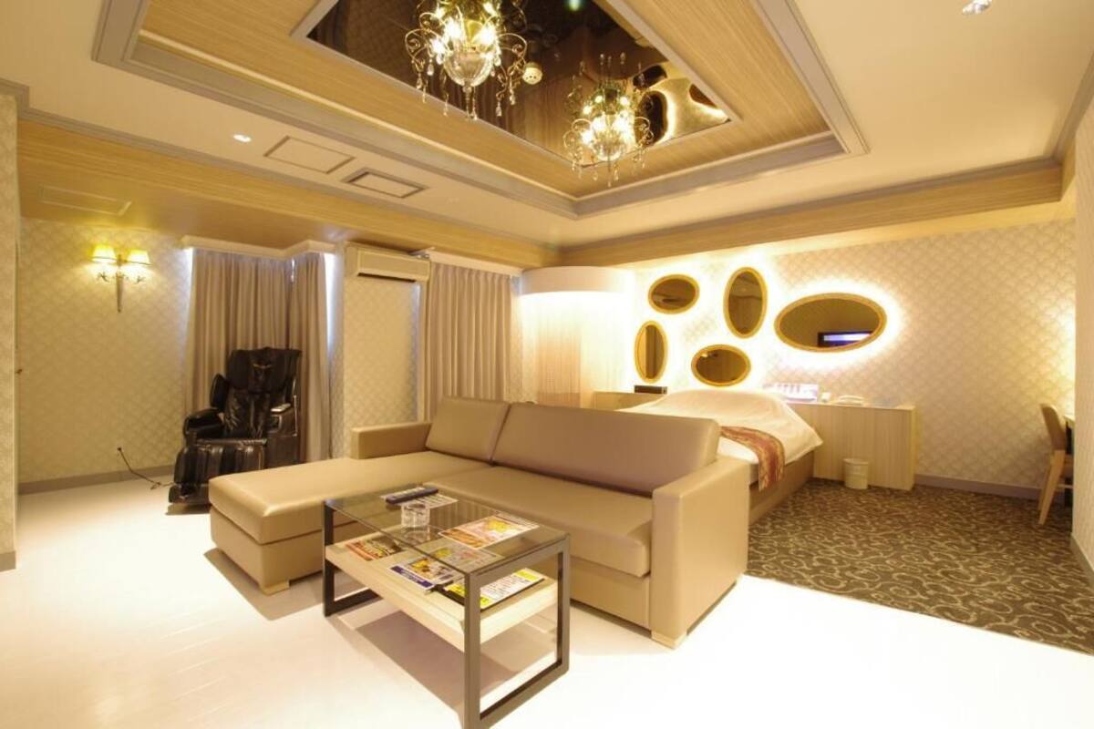 A modern living room with a sofa, coffee table, and a ceiling light fixture.