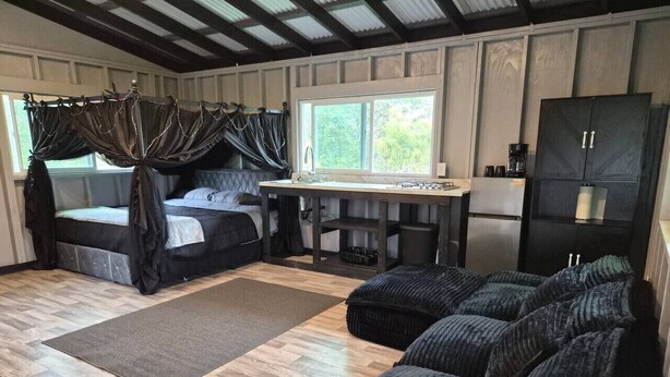 A cozy room with a bed, a desk, a chair, and a wardrobe. - Jungle Lux Cabin - Private Retreat w/ AC & WiFi (Keaau)