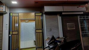 A hotel entrance with a neon sign reading 'Sapphire Guest House.' - sapphire guest house (Kolkata)